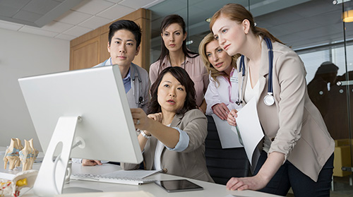 Group of Physicians Around Computer